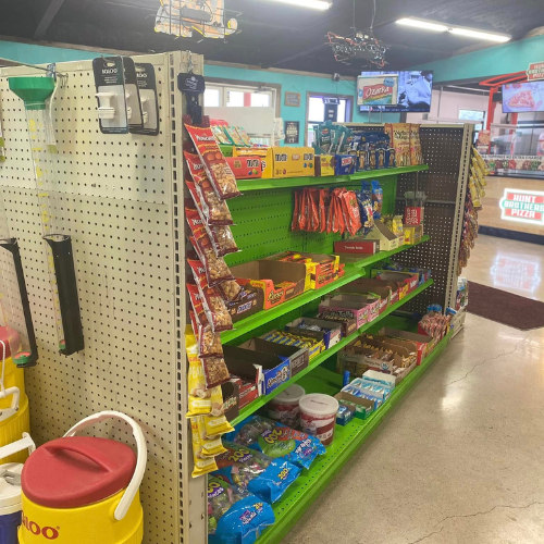 Inside Hamilton Farm & Ranches convenience snack aisle overview