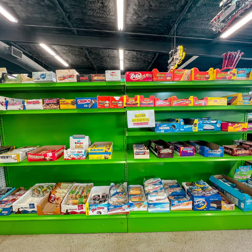 Inside Hamilton Farm & Ranches convenience snack aisle overview